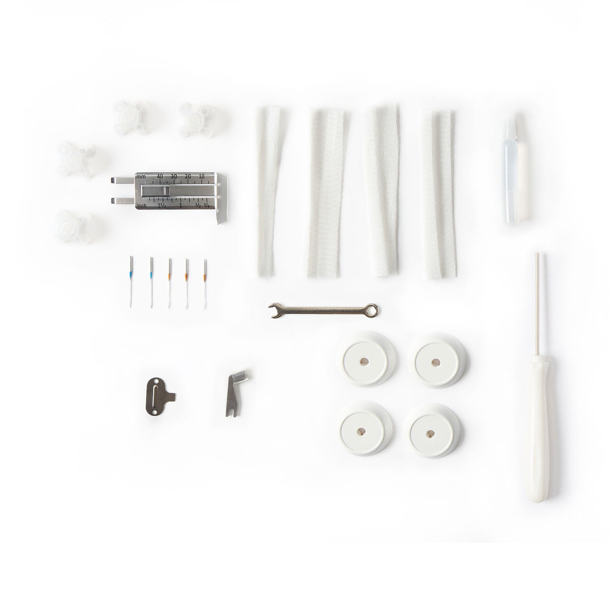 Singer S0600 serger included accessories laid out on a white background
