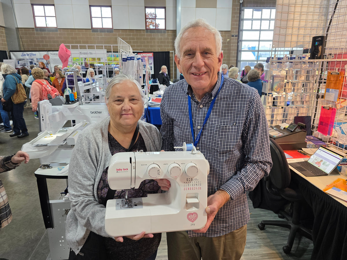 Sewing machine winner at the Quality Sewing booth