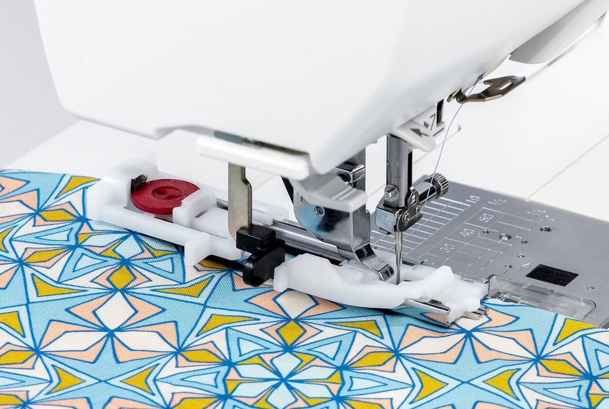 Janome Memory Craft 1000 automatic buttonhole foot with a button on printed fabric