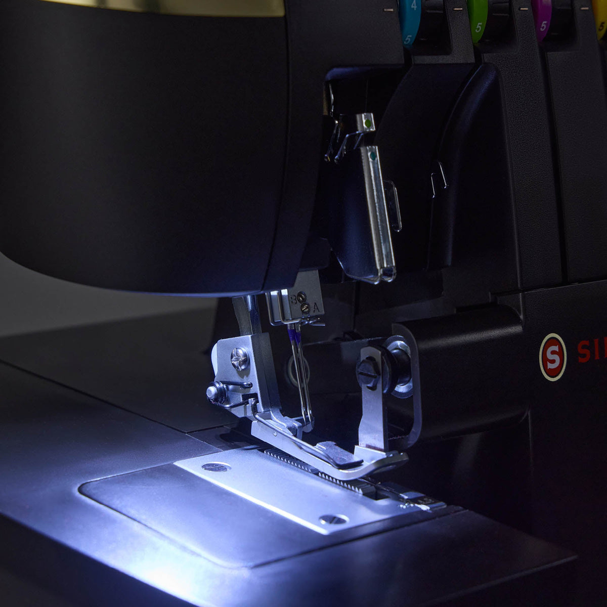 Singer HD0500S needle and presser foot area lit by the lower looper LED