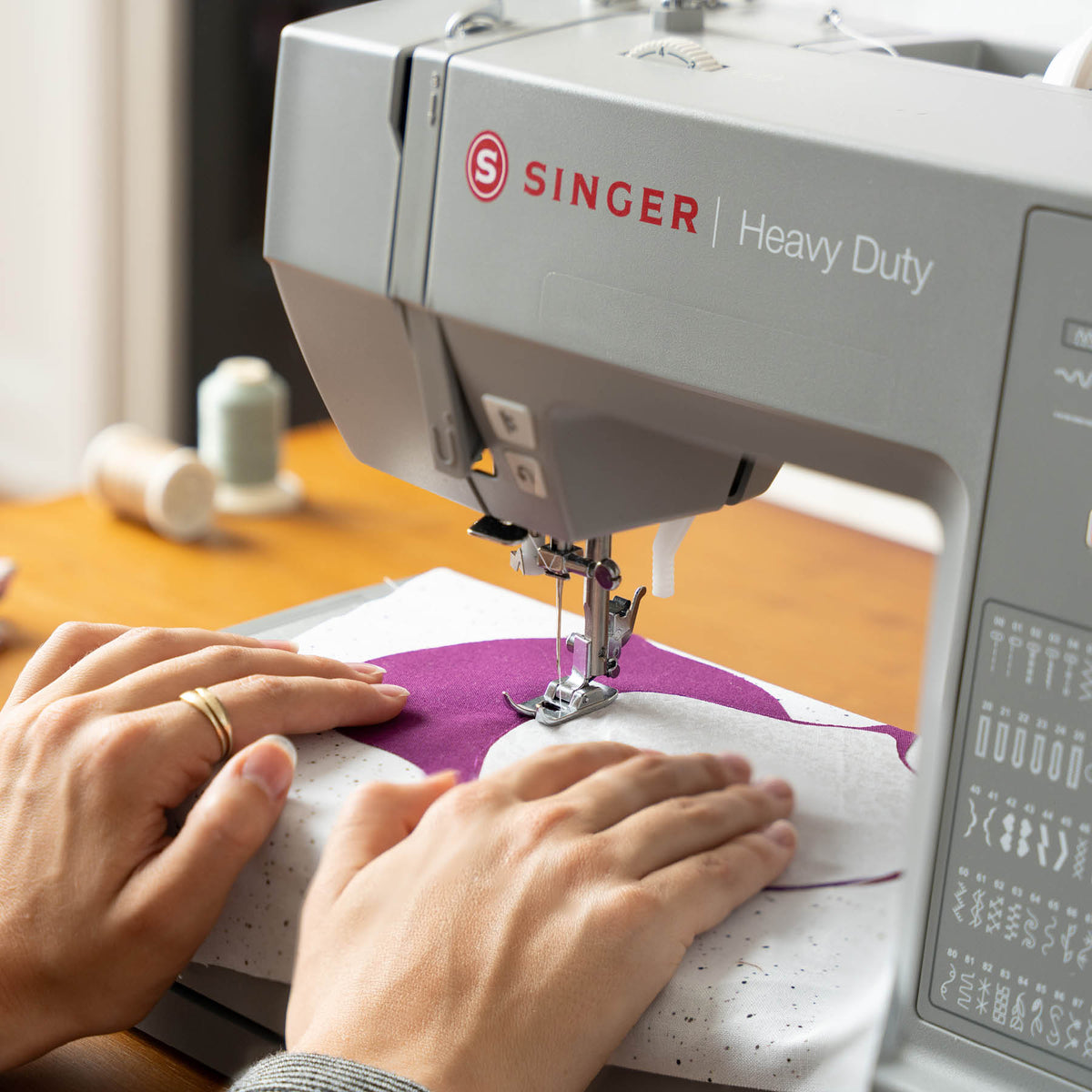 Singer Heavy Duty 6600C sewing purple fabric, close view of the presser foot and needle