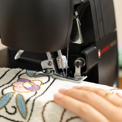 Close-up of the Singer HD0500S needle and presser foot on embroidered fabric