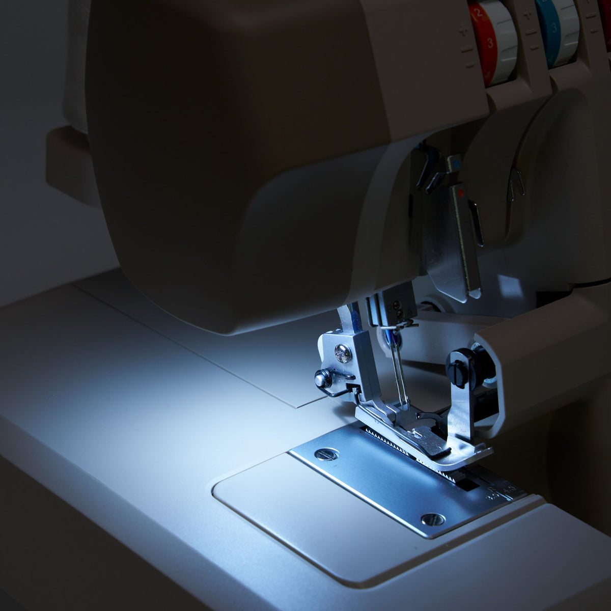 Singer HD0420 serger LED light shining on the needle area and stitch plate
