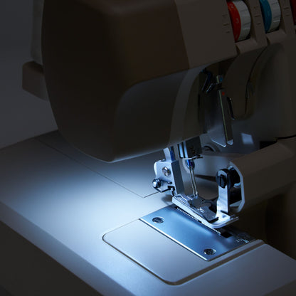Singer HD0420 serger LED light shining on the needle area and stitch plate