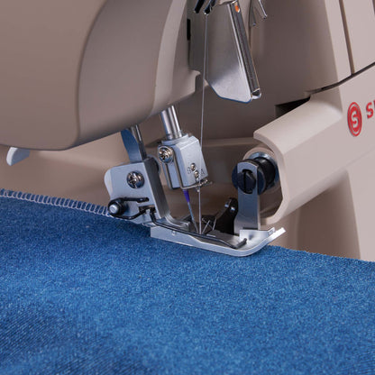 Singer HD0420 serger presser foot and needle area on blue denim fabric