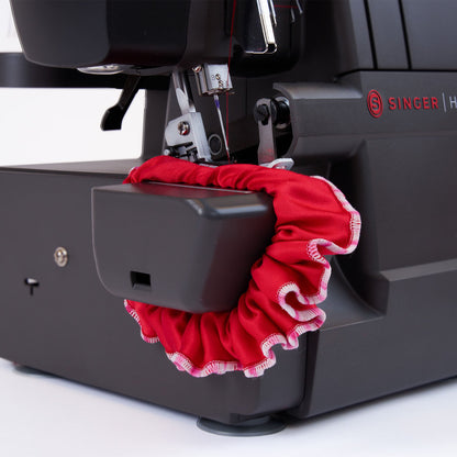 Singer HD0460 serger free arm with gathered red fabric around the arm