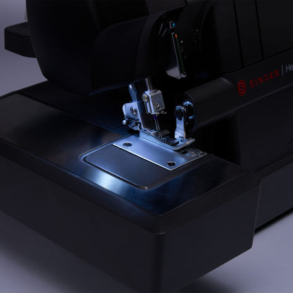 Singer HD0460 serger LED light shining on the needle area and stitch plate