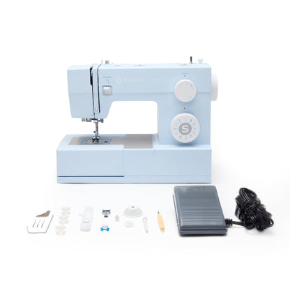 Singer Heavy Duty 4423 with foot control, presser feet, bobbins and tools laid out in front