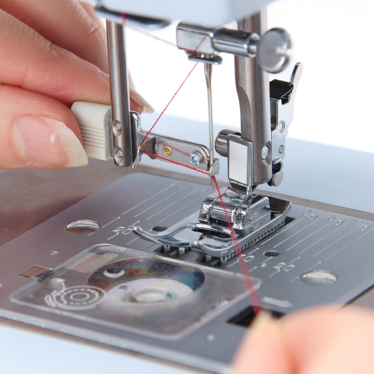 Singer Heavy Duty 4423 built-in needle threader in use at the needle