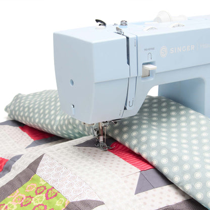 Singer Heavy Duty 4423 sewing a patchwork quilt top with fabric in the sewing space