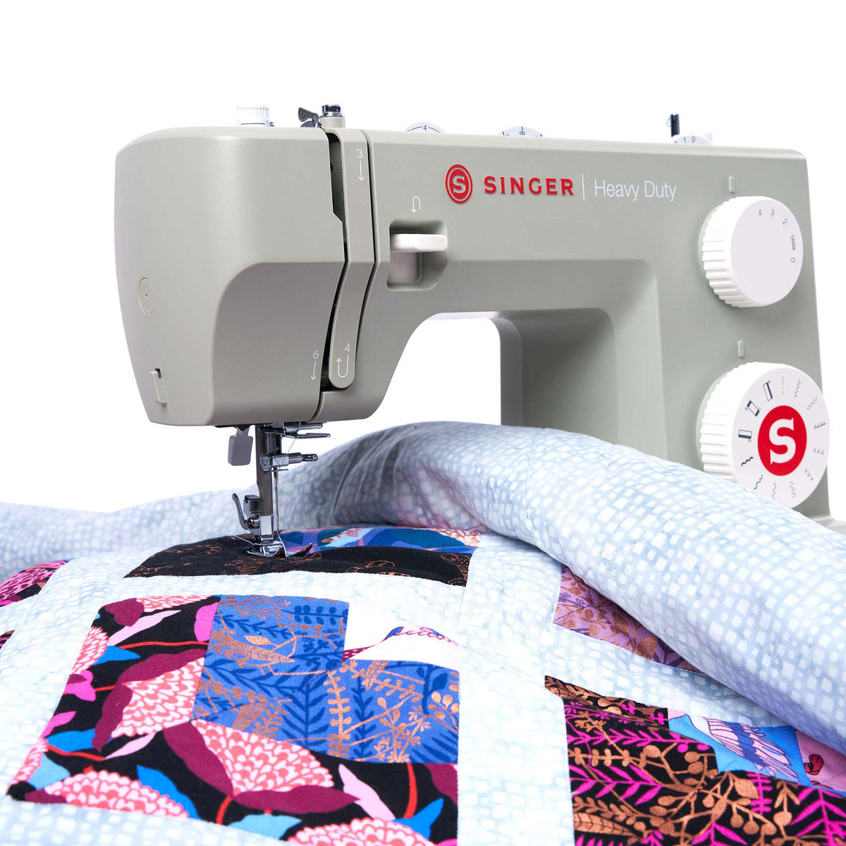 Singer Heavy Duty 4511 Sage with a patchwork quilt under the needle