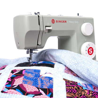 Singer Heavy Duty 4511 Sage with a patchwork quilt under the needle