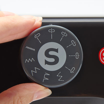 Hand turning the stitch selector dial on the Singer M1000 Black