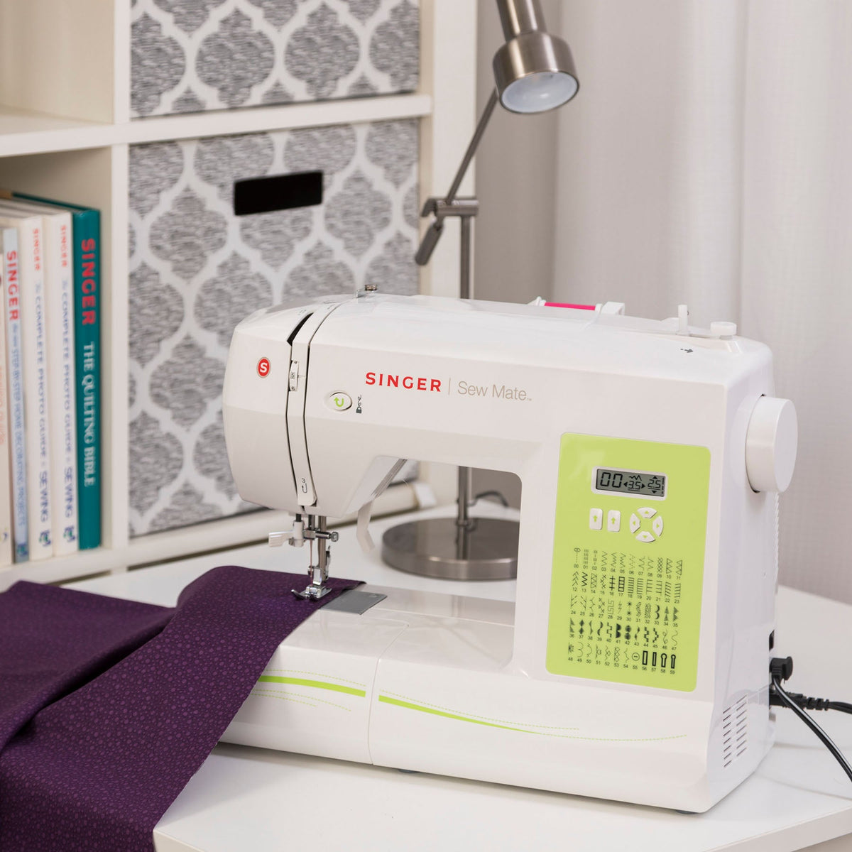 Singer Sew Mate 5400 sewing a seam in purple fabric with the LCD screen visible