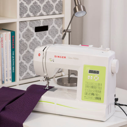Singer Sew Mate 5400 sewing a seam in purple fabric with the LCD screen visible