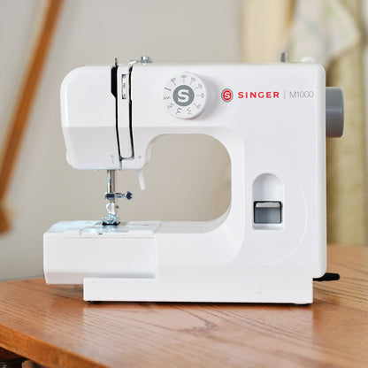 Singer M1000 mending machine on a wooden table