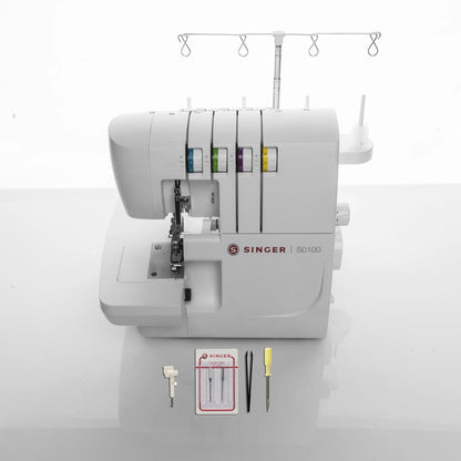 Singer S0100 serger shown with its included foot, needles, tweezers, and screwdriver
