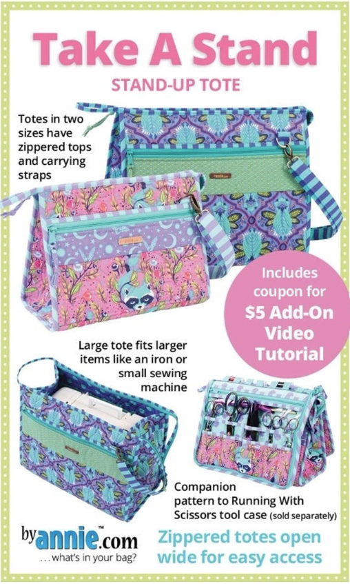 Two triangular standing tote bags underneath the title "Take A Stand: Stand-Up Tote" One is purple and is larger than the pink one next to it. Both bags are pictured again below; the larger one having a small sewing machine inside, and the smaller with a tool case propped up against its side. The tool case has a set of scissors visible on it's side. In between the images are various product features written out.